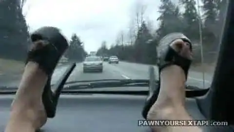 Feet on the dashboard masturbating in the car on the highway