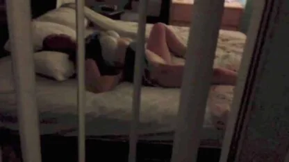 woman undressing in front of open window in motel room