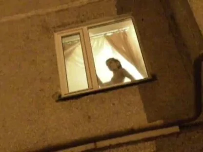 Naked girl showing off in the window
