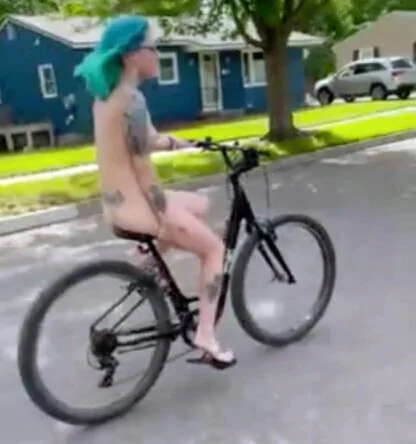 Nude Blue Haired Girl Riding Bicycle