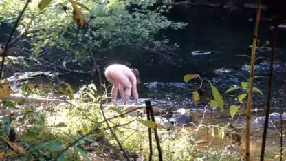 Naked Girl Bent Over at the Creek Washing Up